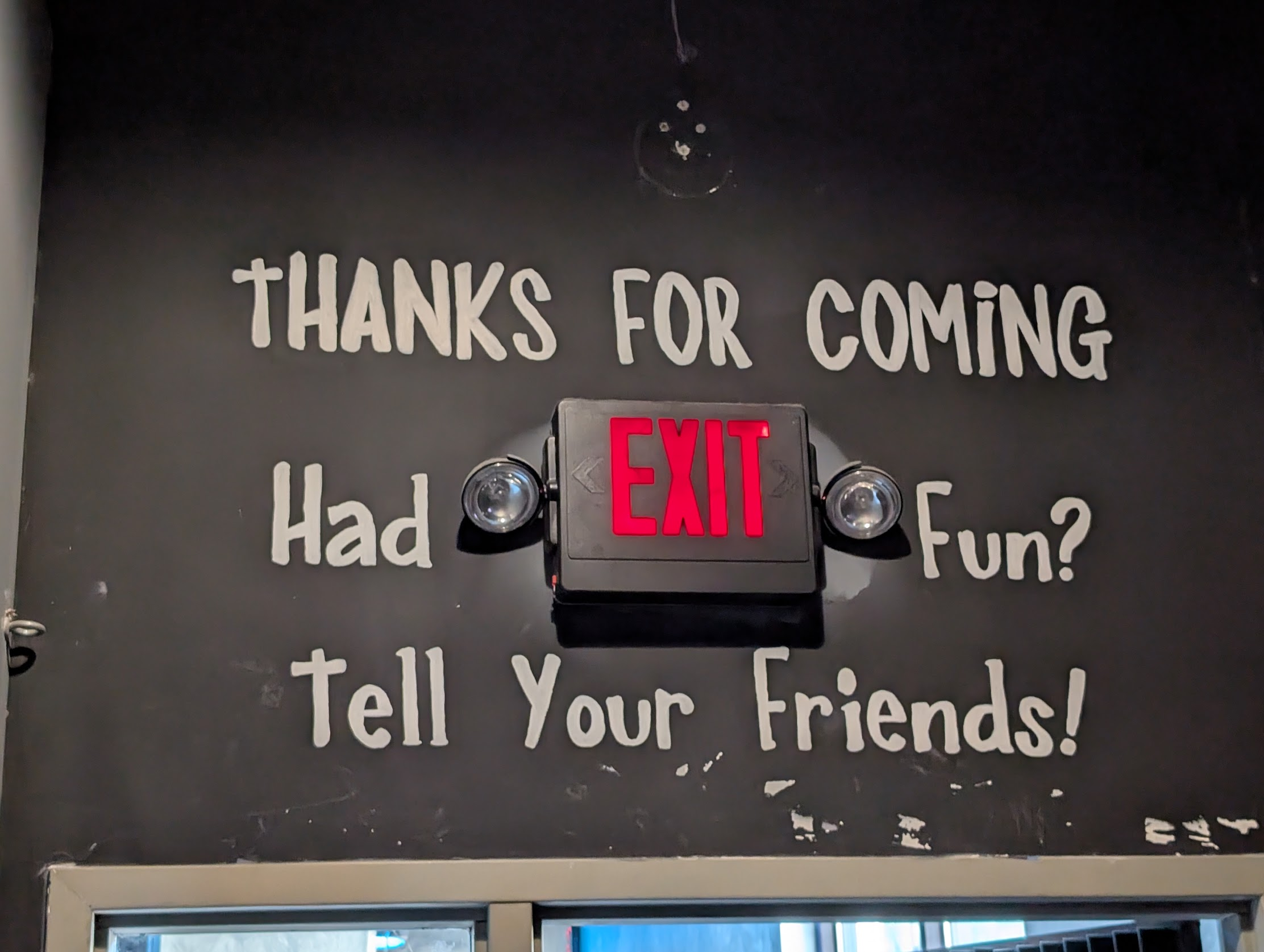 Exit sign at Limelight theater that says: Thanks for coming Had fun? Tell your friends!